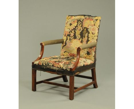 A late 19th century Gainsborough style armchair, with tapestry back and seat and with carved and fluted arm supports and rais