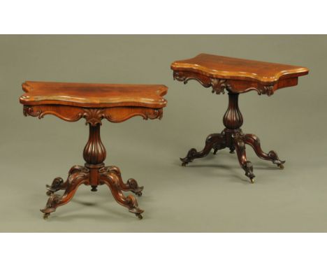 A pair of Victorian rosewood serpentine fronted turnover top card tables, each with moulded edge and applied carved frieze mo