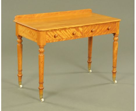 A Victorian satinwood dressing table, with low gallery fitted two drawers on turned legs and white ceramic castors.  88 cm hi