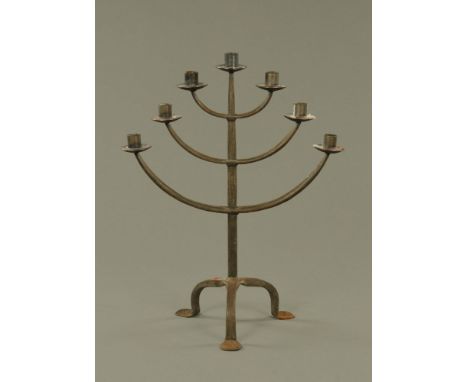 A wrought iron seven sconce candlestick, 52.5 cm high.
