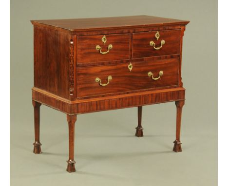 A 19th century mahogany Chippendale style chest on stand, with moulded edge above two short and one long drawer flanked by ca