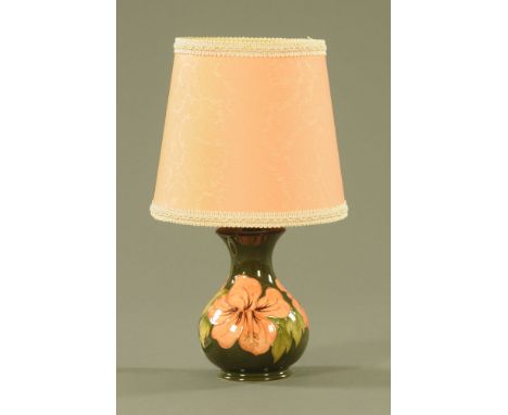 A Moorcroft table lamp with shade, with green ground and orchid pattern, impressed Moorcroft.  Height excluding light fitting