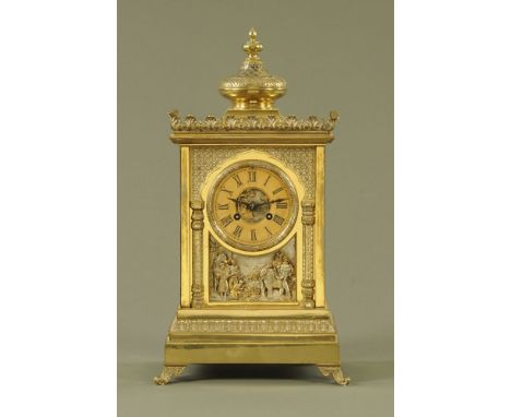 A 19th century gilt brass cased bracket clock, in the Eastern style decorated in relief with huntsman and elephant being atta