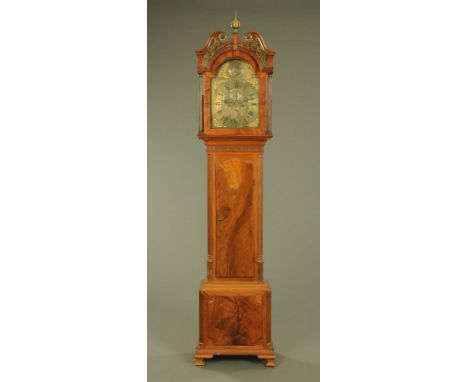 A George III mahogany longcase clock, with swans neck pediment above the arched brass dial and two train striking movement wi