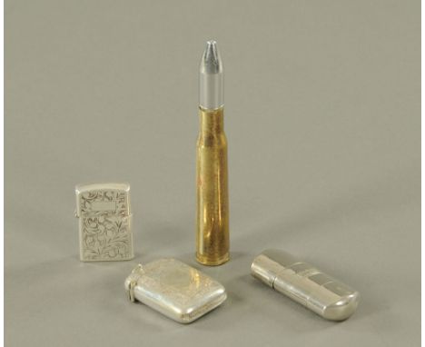 A vintage silver cased cigarette lighter, two others and a Vesta case.