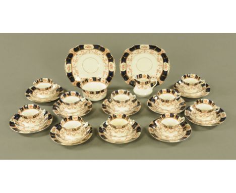 A diamond china tea service, 10 cups, saucers and plates, sugar basin, cream jug and 2 sandwich plates.