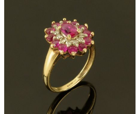 A 9 ct gold ruby and diamond cluster ring, Size K.