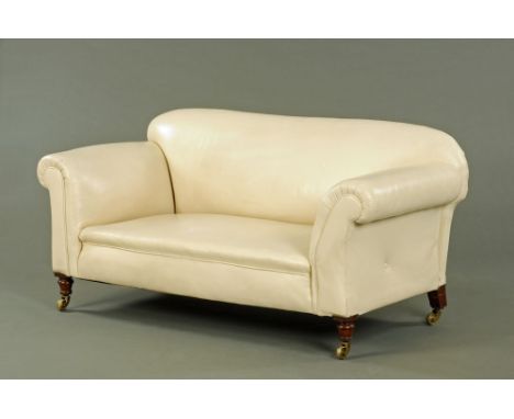 A late Victorian Chesterfield settee, upholstered in cream leather and raised on turned front legs terminating in brass casto