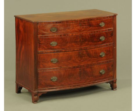 A Regency mahogany bow fronted chest of drawers, four long graduated with brass drop handles with oval backplates flanked by 