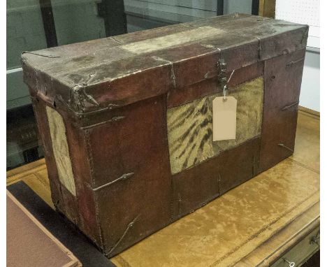 TIBETAN TRUNK, leather and animal hide with a rising lid, 31cm x 51cm H x 83cm.