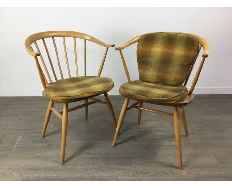 SET OF THREES ERCOL 'COW HORN' ARMCHAIRS,in elm and beech, stick backs and swept arms, on spindle legs joined by an H-stretch