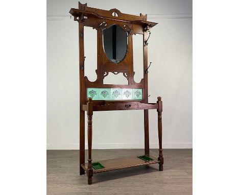 ARTS & CRAFTS OAK HALLSTAND,with pierced cornice over a bevelled shield shaped mirror, a series of coat hooks and five tiles,