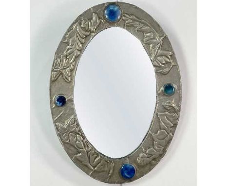 ARTS &amp; CRAFTS WALL MIRROR,the polished pewter frame with relief floral decoration and inset with four Ruskin-type high fi