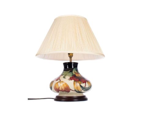 MOORCROFT TABLE LAMP,of squat baluster form, with floral tube lined decoration on navy and cream grounds, on wired base, 22cm