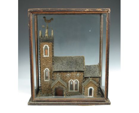 A Victorian model of a church in a glazed case, a gilt cockerel wind vane on top of the square tower, the round arched staine