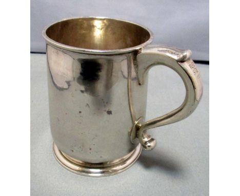 A George I silver pint mug, by George Boothby, London 1723, of tapering cylindrical shape with tucked in foot ring, scroll ha