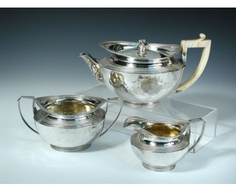 A George III three piece silver tea set, by John Emes, London 1803, comprising: a teapot of hemispherical form, with sack wea