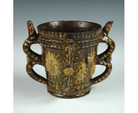 A Wrotham tyg dated 1696, the brown tapering sides with sprigs in yellow of I.E for the potter John Eaglestone, the initials 