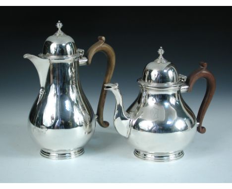 A modern silver coffee pot and matching tea pot, by Charles Stuart Harris & Sons, London 1932, each of plain pear shape below