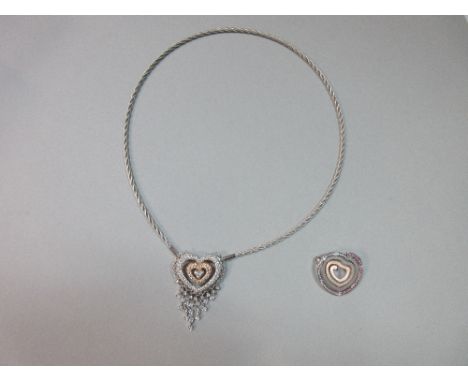 An 18ct white gold necklace with diamond heart centrepiece and interchangeable pink sapphire and diamond centrepiece, the rop