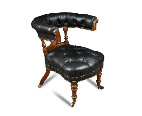 A 19th century oak framed library or conversation chair, with horseshoe arched back, button upholstered in dark green leather
