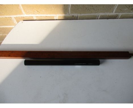 A 19th century boxwood rule with slide measures either side together with an ebony cylindrical ruler, the slides to the broad
