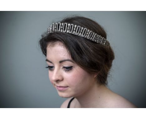 An Edwardian diamond tiara, the gift of the 6th Earl Spencer to his daughter, composed of alternating linear and oval motifs 