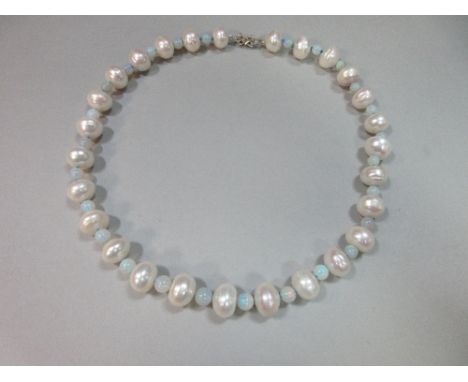 An opal and large pearl necklace with diamond clasp, the slightly graduated line of 6-8mm precious opal beads alternating wit