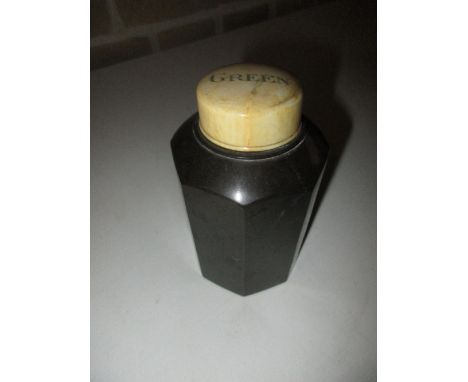 A serpentinite 'Green' tea caddy, the bottle shape with octagonal sides, the ivory screw top inscribed, 11.5cm (4.5 in) high 