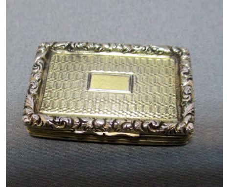 A William IV silver gilt vinaigrette, by Francis Clark, Birmingham 1835, rectangular with engine turned design within a folia