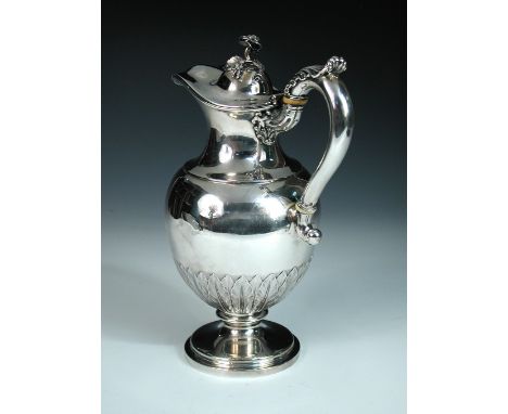 A William IV silver ewer, by Paul Storr, London 1837, raised on a circular foot, the ovoid body embossed with stiff leaf desi