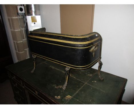 A 19th century gilt black tole plate warmer, the gilt lined rim inverted over a shelf below on four foliate decorated cabriol