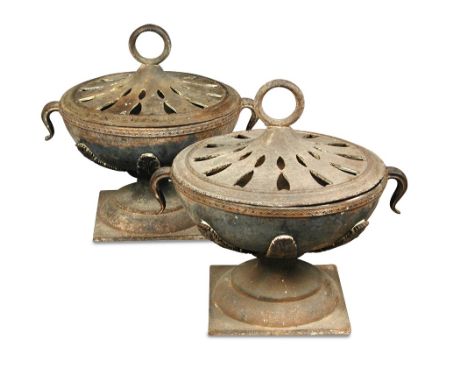 A pair of two handled iron bowl braziers with pierced covers, the latter with central ring handles and with two bands of pier