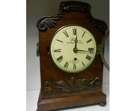 A Victorian mahogany mantel timepiece, the shaped top case with metal side ring handles, 6inch (15cm) painted dial marked 'Wi
