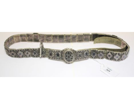 A 19th century Russian lady's belt, formed from thirty-four rectangular, embossed and niello decorated sliding panels contain