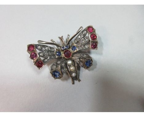A Victorian butterfly brooch set with diamonds, rubies, sapphires and pearls, the four wings set with rose cut diamonds and e