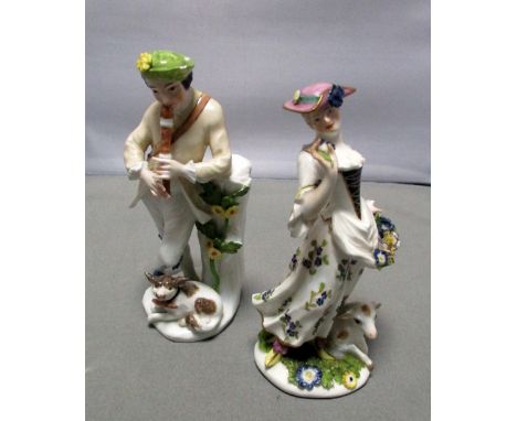 A pair of Meissen figures of a shepherd and shepherdess, he playing with a pipe leaning on a tree stump wearing a green hat w