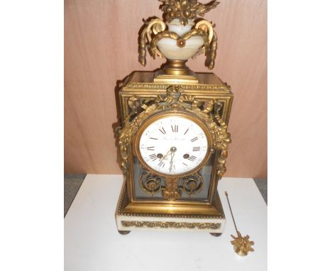 Maison Marnyhac, Paris, a late 19th century ormolu and white marble mantel clock, the glazed rectangular case with urn surmou