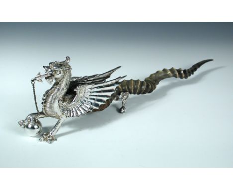 A Victorian electroplate table cigar lighter by Henry Wilkinson & Co, in the form of a dragon, his right front foot resting o