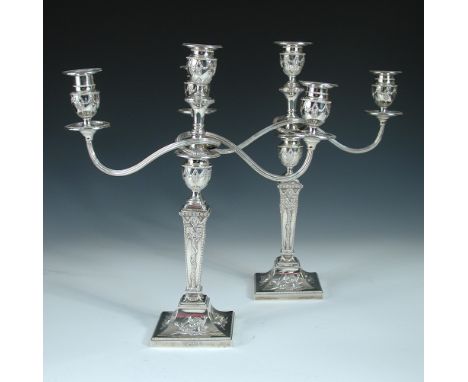 A pair of Edwardian silver candelabra, by Thomas Bradbury & Sons Ltd, London 1906/1908, each with square bead edged foot embo