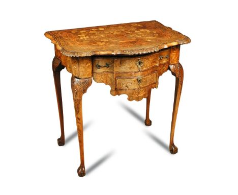 A 19th century Dutch walnut and marquetry inlaid side table, serpentine outline, fitted two drawers, carved border and legs, 