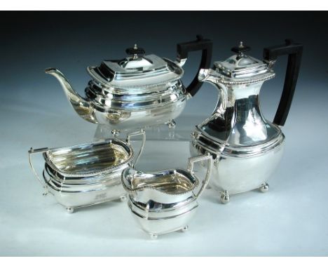 An Edwardian silver four piece tea set, by Z Barraclough & Sons, Sheffield 1910 (hotwater jug 1907), comprising:- a teapot of