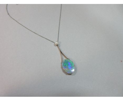 A black opal and pearl pendant necklace, the oval flat cut opal, length 16mm, displaying principally turquoise, green, purple