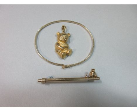 A 9ct gold teddy pendant with diamond eyes together with a bear and diamond bar brooch and a diamond set wire bangle, the pen