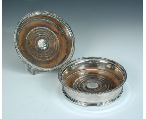 A pair of George III silver wine coasters, probably by Richard Sibley, London 1806, each of plain circular shaped below a gad