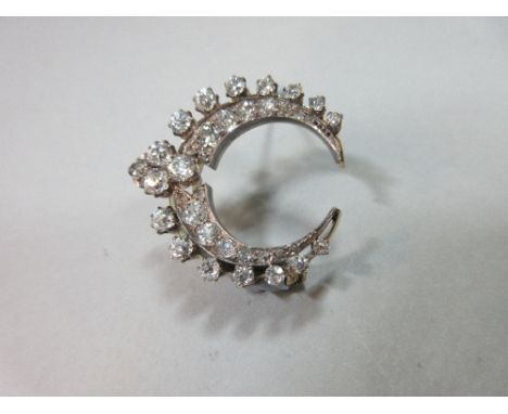 A Victorian diamond fancy crescent or initial C brooch, the closed crescent of close-set graduated old round brilliant cut di