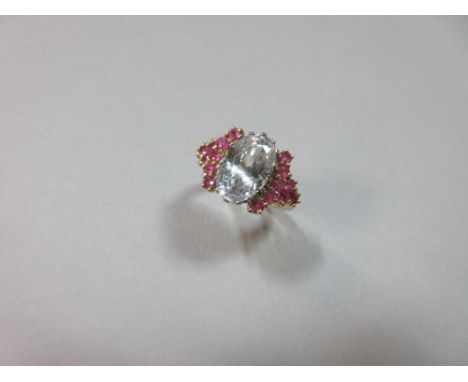 A large white sapphire and pink sapphire ring in 18ct gold, the ice white-blue oval cut sapphire, estimated weight 7.29cts, c