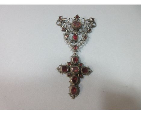 An 18th century corsage ornament, probably Iberian, designed as an articulated drop of foliate wirework with pendant cross, s