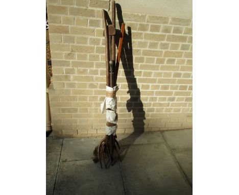 Five various long handled tools, to include: two forks with contiguous treen tines, a brush, an iron crescent bladed tool and