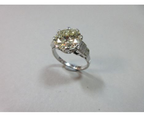 An impressive single stone diamond ring of approximately 4cts, the round brilliant cut diamond, eight claw set between tiered